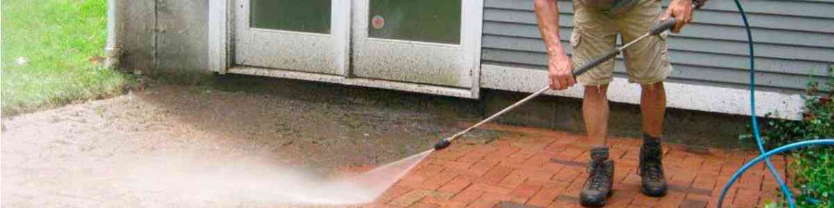 Brick patio getting cleaned with high pressure water.